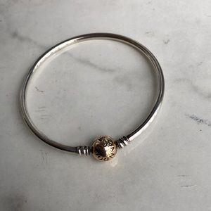 Sterling silver bangle bracelet w/ 14k gold clasp.
